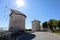 Traditional windmill in Alacati, Turkey in sunny autumn day with blue sky on background