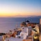 Traditional windmill and apartments in Oia, Santorini, Greece at