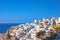 Traditional windmill and apartments in Oia village in Santorini