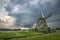 Traditional windmill in Holland under a stormy sky