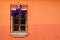 Traditional window on orange wall with semana santa ribbon decoration in Antigua, Guatemala