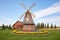 traditional wood windmill with brick base in grassland