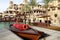 Traditional wooden arabic boat on the background of beautiful buildings in Madinat Jumeirah