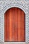 The traditional  wooden arched door and brick wall,which has the