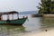 Traditional wooden boat in Cambodia. Koh Rong island seaside view with coral beach and fisherman boat.