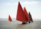 Traditional wooden boats with red sail.