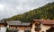 Traditional wooden cottage mountain houses in the green field in the dolomites. Housing in Italian apls. Alpine region