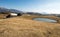 Traditional wooden cottages on Velika Planina high pasture with small lake