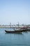 Traditional wooden dhows in Doha, Qatar. The skyline of the modern and high-rising city of Doha as the background.