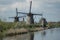 A traditional wooden Dutch windmills in the Netherlands at the river - Kinderdijk