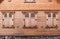 Traditional wooden facade of an old town buildings in Latvia. Wooden house facade with closed shutters.