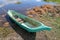 Traditional wooden fishing boat of Balinese fishermen on Lake Batur, called Perahu. Boat made from one piece of trunk. Green boat.