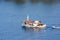 A traditional wooden fishing boat floating on the colorful waters, Ermioni, Greece