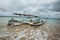 a traditional wooden fishing boat rests on the beach