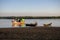 Traditional wooden fishing boats by the shore during sunset, Chaung Thar, Irrawaddy, Myanmar