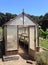 Traditional wooden greenhouse in a garden