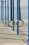 Traditional wooden gymnastic rings hanging on black straps in a clear blue sky