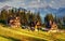 Traditional wooden house in the mountains on a green field