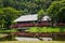 Traditional wooden houses and bushes of red color. Iban longhouse Kuching to Sarawak Culture village. Malaysia