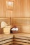 Traditional wooden sauna for relaxation with bucket of water