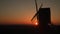 Traditional wooden windmill at sunset