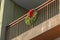 Traditional wreath with red bow on a balcony rail
