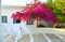 Traditional yard with blooming pink bougainvilleas at Koufonisia islands Cyclades Greece - the wind blows the laundry towels