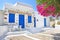 Traditional yard with blue windows and bougainvilleas at Koufonisia islands Greece