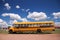 A traditional yellow school bus running its service in the dry desert of Arizona