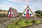 Traditionall hut houses and garden of Madeira on the village Santana on a sunny day in Portugal