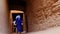 A traditionally dressed Bedouin Moroccan man walks inside the Kasbah in Mhmaid, Morocco.