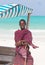 Traditonaly dressed maasai black man on picture perfect tropical Paje beach, Zanzibar, Tanzania, East Africa.