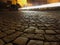 Traffic on cobblestone road at night