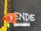 Traffic cone on marker with the word end.