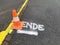 Traffic cone on marker with the word end.