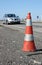 Traffic cone on road with car