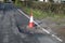 Traffic cone and road subsidence around manhole