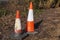 Traffic cones abandoned on waste land near woods Secu