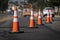 Traffic cones on road with electronic arrow pointing to the right to divert traffic