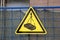 Traffic construction yellow triangular sign warning about falling weigh from height on construction site