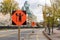 Traffic control person ahead road sign due to construction work in downtown of Ottawa, Canada