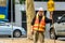 A traffic control worker is holding SLOW sign