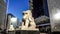 The traffic and couple of marble lion sculpture in Beijing Financial Street,China. Panning
