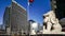 The traffic and couple of marble lion sculpture in Beijing Financial Street,China. Panning