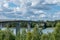 Traffic crossing a bridge over water in sunshine