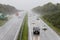 Traffic driving in heavy rain on dual carriageway