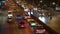 Traffic flow on busy street in the business district at night. Cars traffic at the intersection. Cars light illuminated