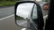 Traffic on German highway - view through rear-view mirror