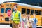 traffic guard crossing road with schoolchildren