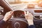 Traffic jam, driving car on highway, close up of driver hands on steering wheel